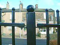 Powder coated vertical bar railings with ball tops close up photo